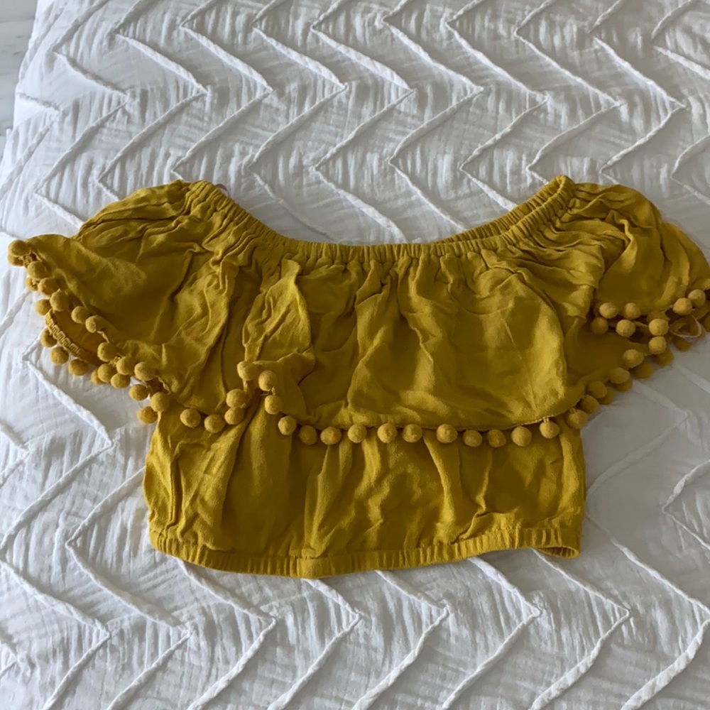 Mustard yellow crop top. With fringe ball detail.